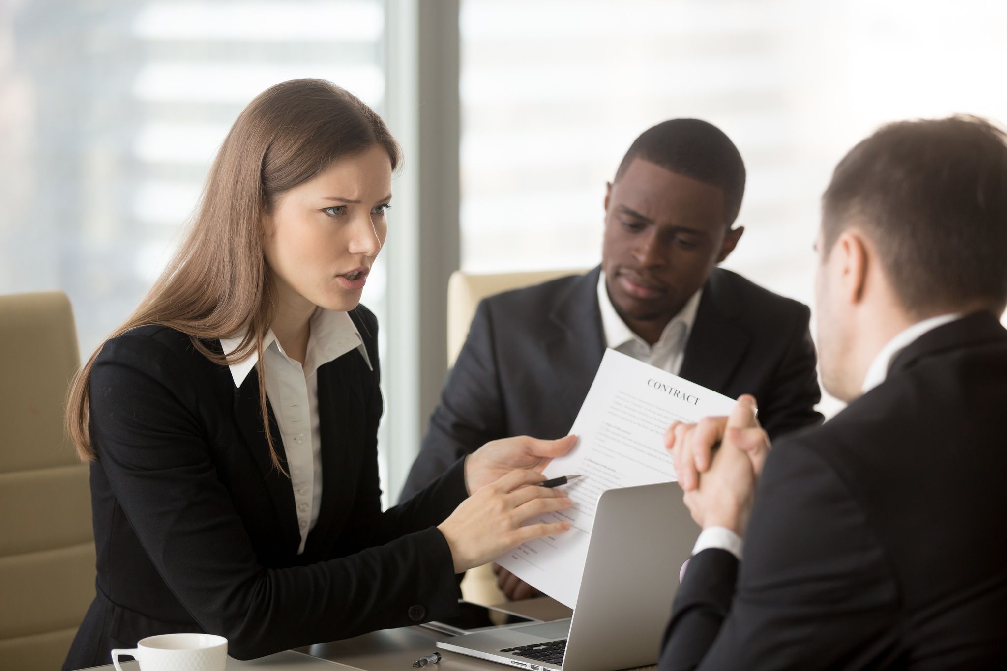 Woman discussing document paper with colleagues