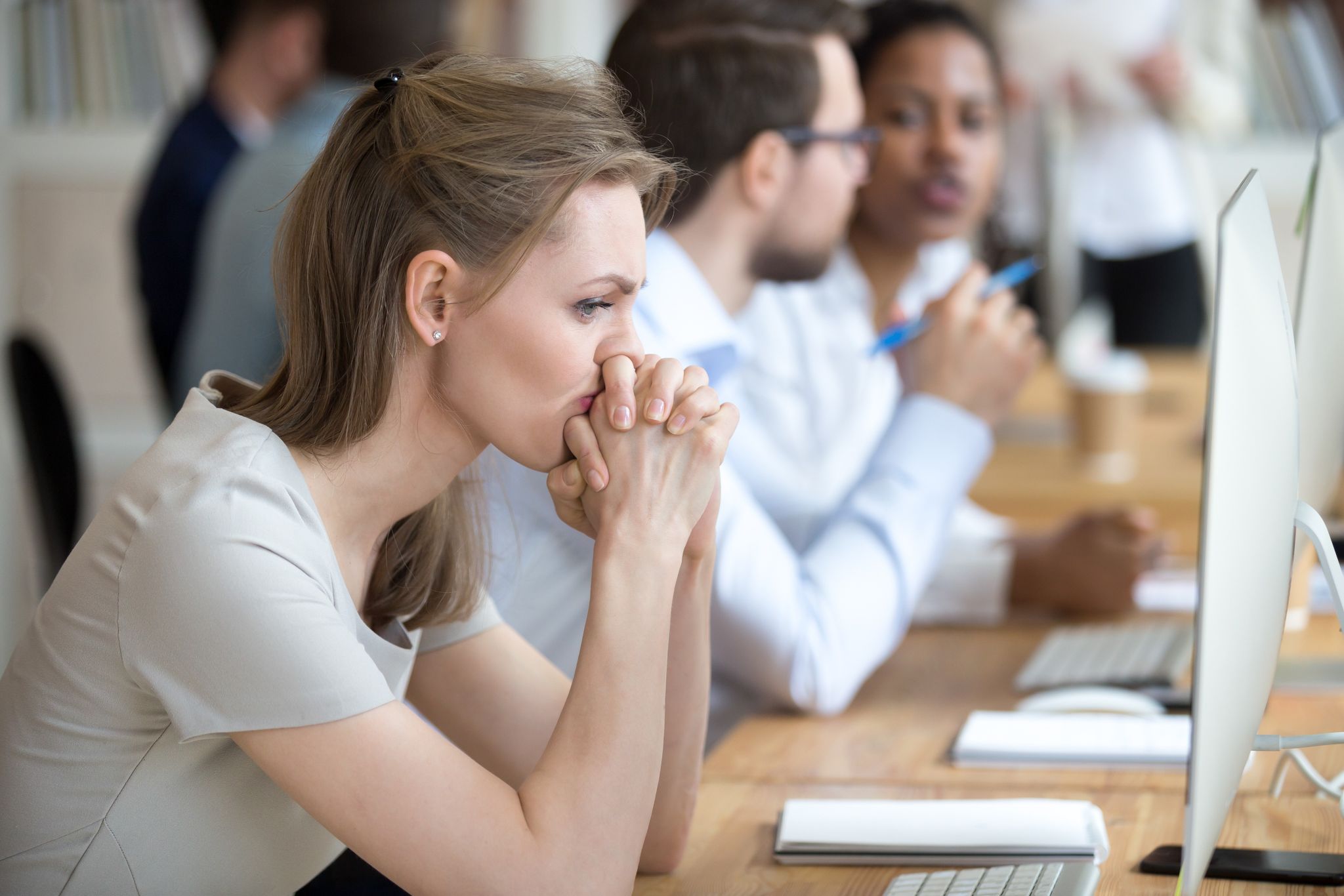 Woman thinking in front of her computer